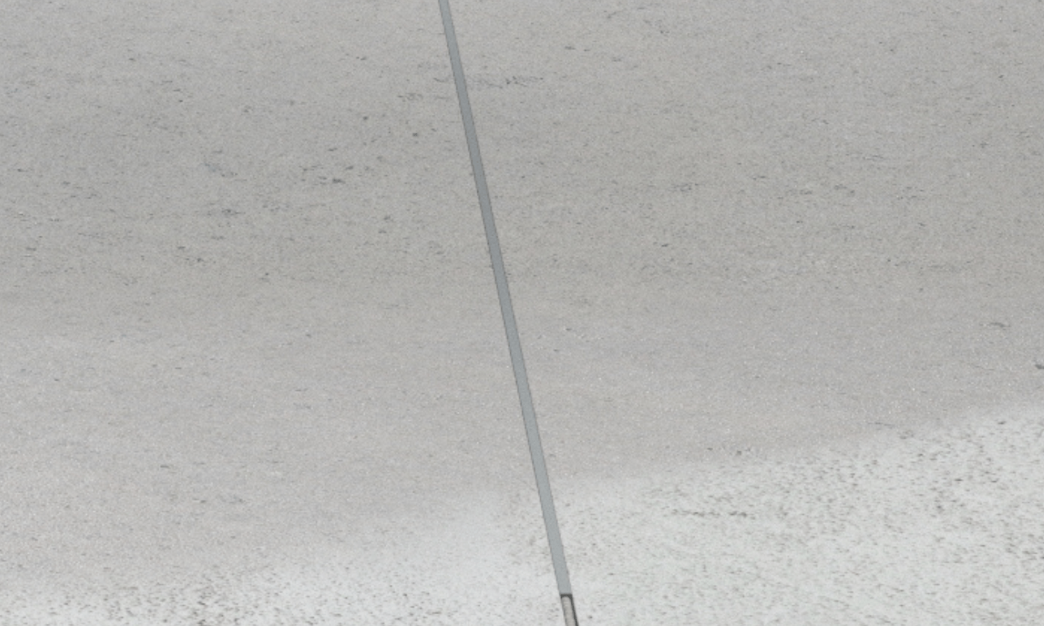 Close-up view of sealing the concrete floor shrinkage joints