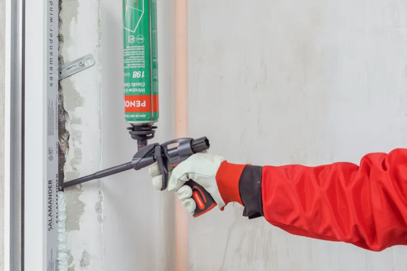 Applying PENOSIL PU foam around a door frame