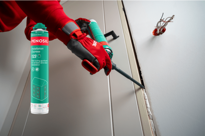A man in red gloves with an installation foam can showcases Penosil Installation Express 123